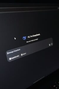 Close-up of a laptop displaying an AI interface with a chatbot prompt in dark mode.